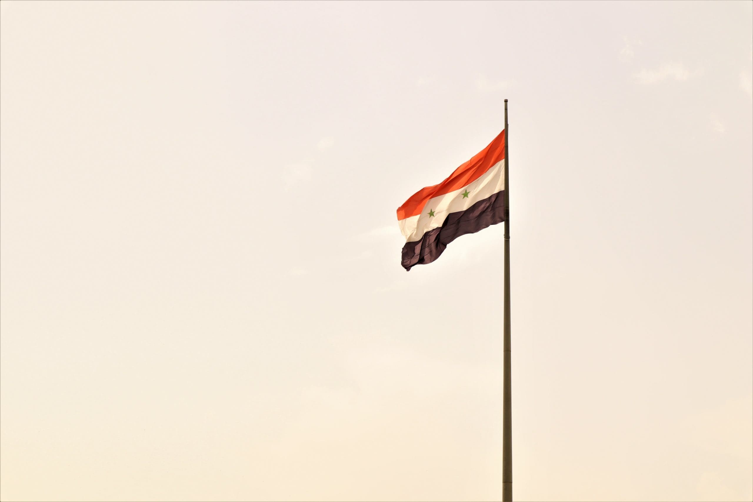 The flag of the Syrian Arab Republic is flying. Syria